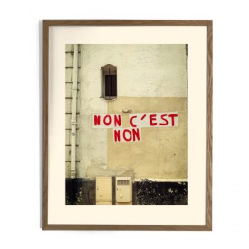 Photographie encadrée d'un mur urbain avec l'inscription en lettres rouges « NON C'EST NON »